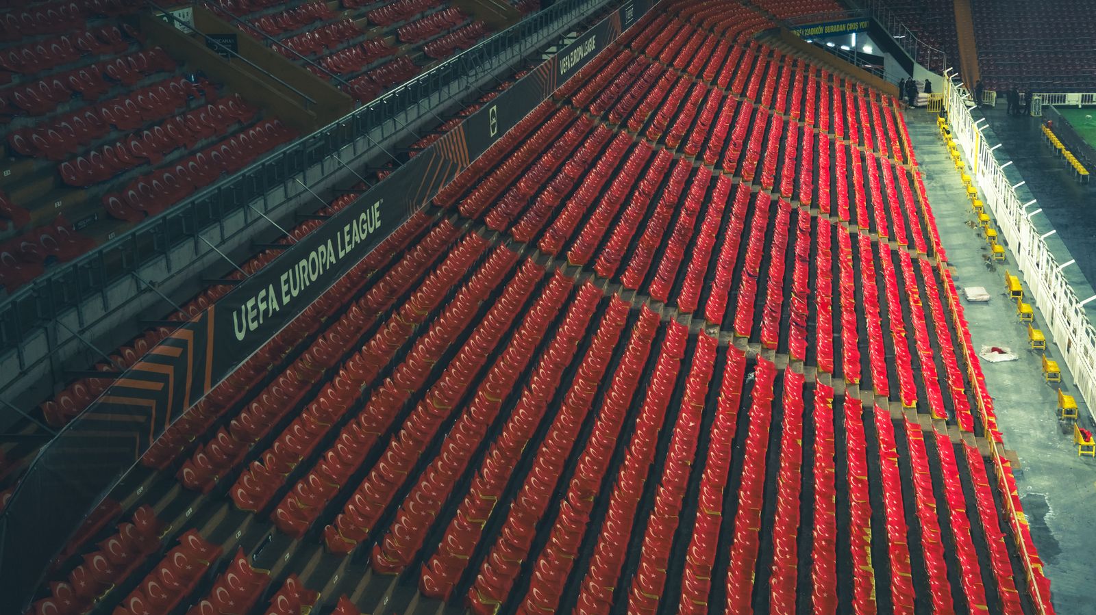 Estadio de fútbol iluminado al atardecer sin espectadores